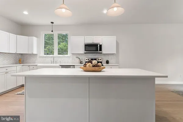 a large white kitchen with lots of counter space and appliances