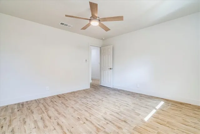 a bedroom with a large bed and paintings on the wall