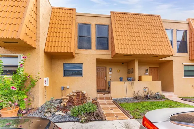 a front view of a house with garden