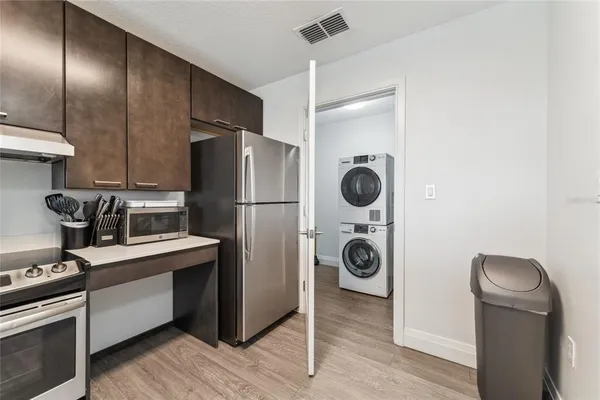 a kitchen with stainless steel appliances granite countertop a refrigerator and a stove