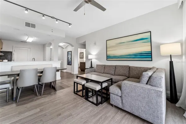 a living room with furniture and wooden floor