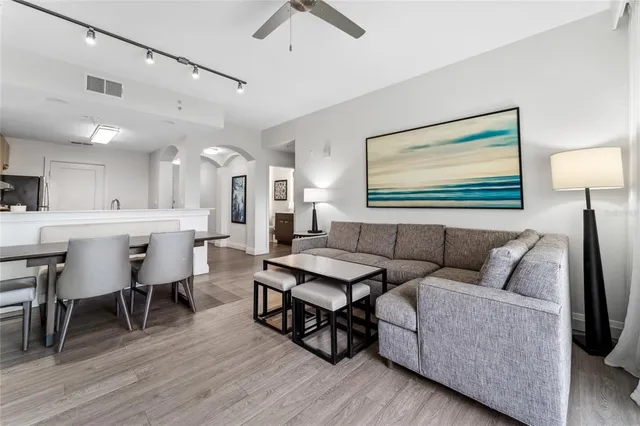 a living room with furniture and wooden floor
