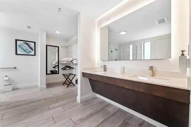 a spacious bathroom with a double vanity sink and a mirror
