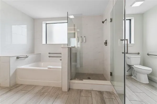 a bathroom with a sink a toilet and shower