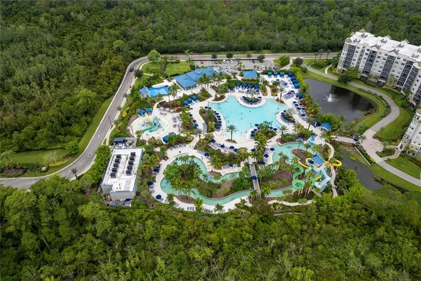 an aerial view of a house with swimming pool and outdoor space