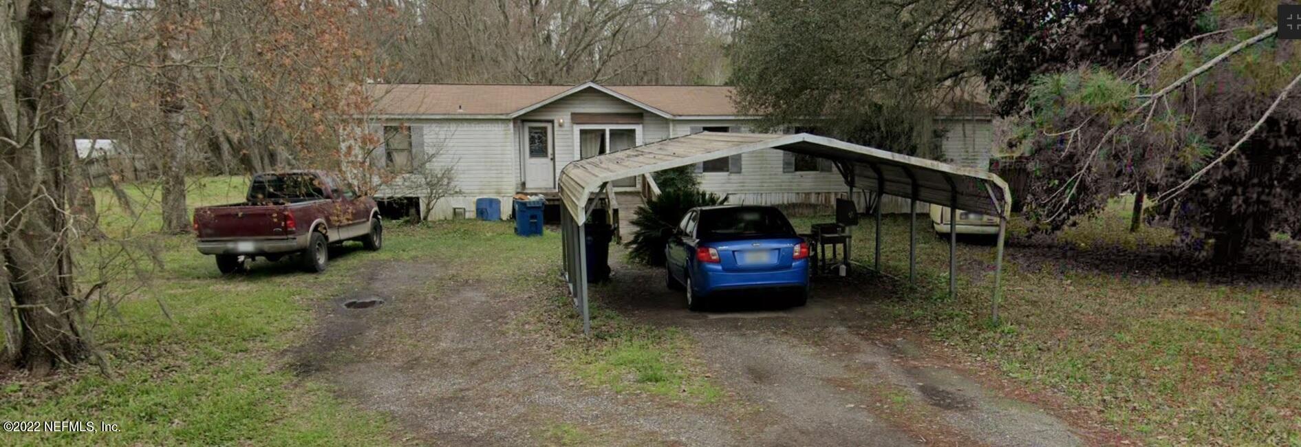 a view of a car is parked in front of a house