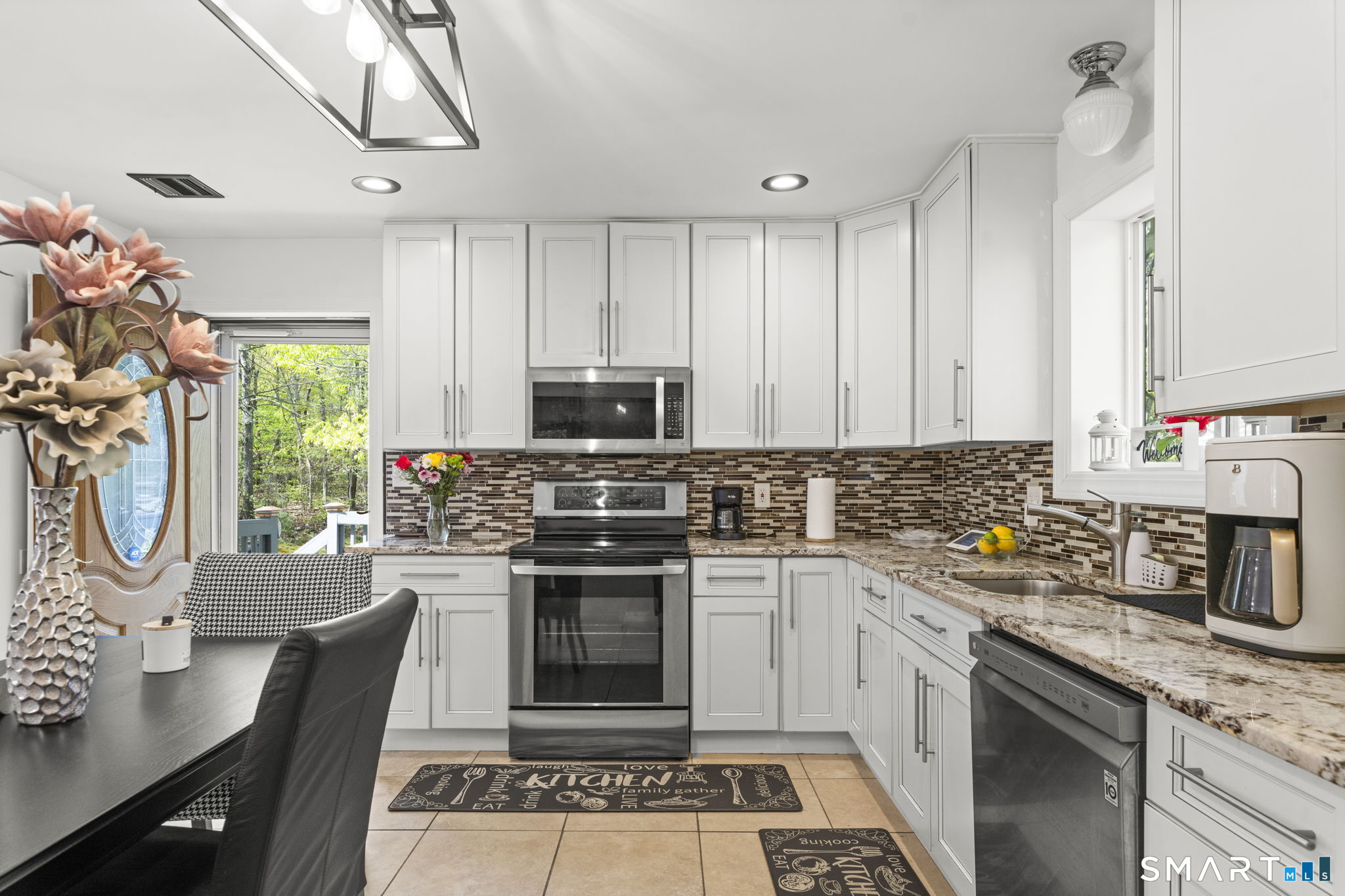 1118 Spindle Hill Road Wolcott, CT 06716 - Photo 12 of 38 a kitchen with stainless steel appliances a stove sink and cabinets