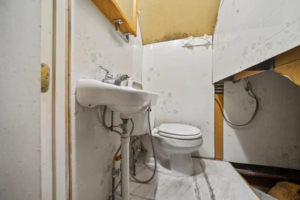 a bathroom with a toilet and a sink