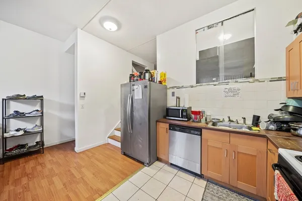a kitchen with stainless steel appliances a refrigerator and a sink
