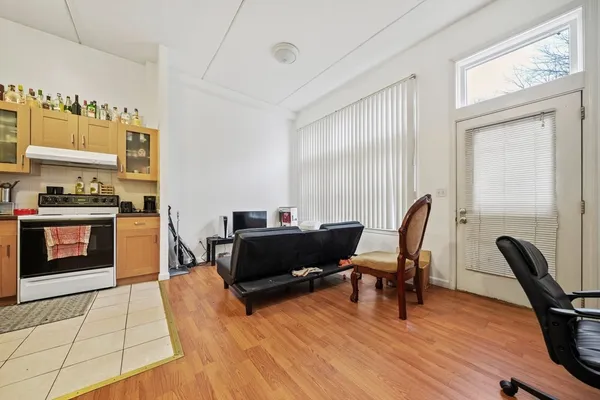 a view of a workspace with furniture and a window