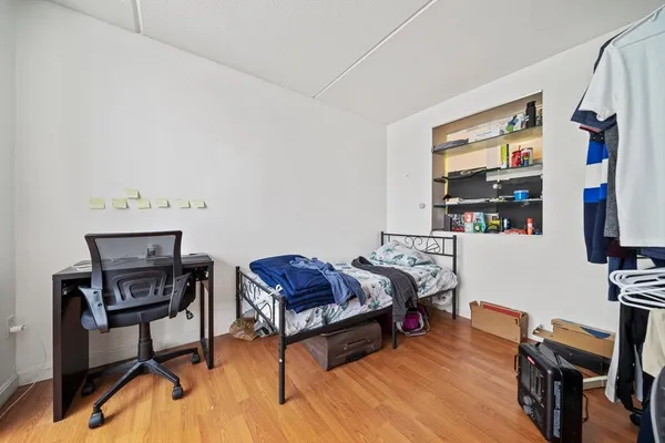 a living room with furniture a flat screen tv and a wooden floor