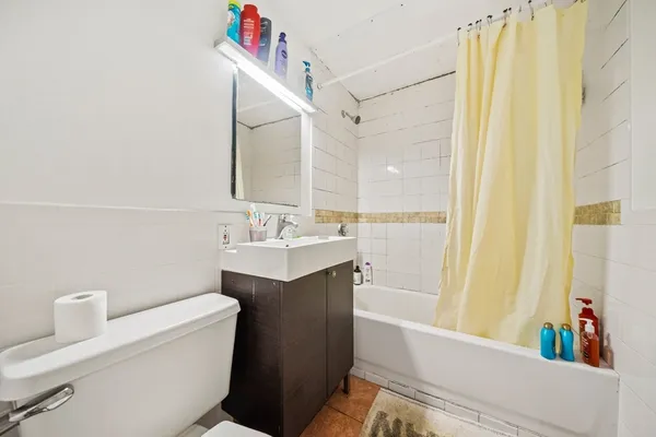 a bathroom with a sink a toilet and shower curtain