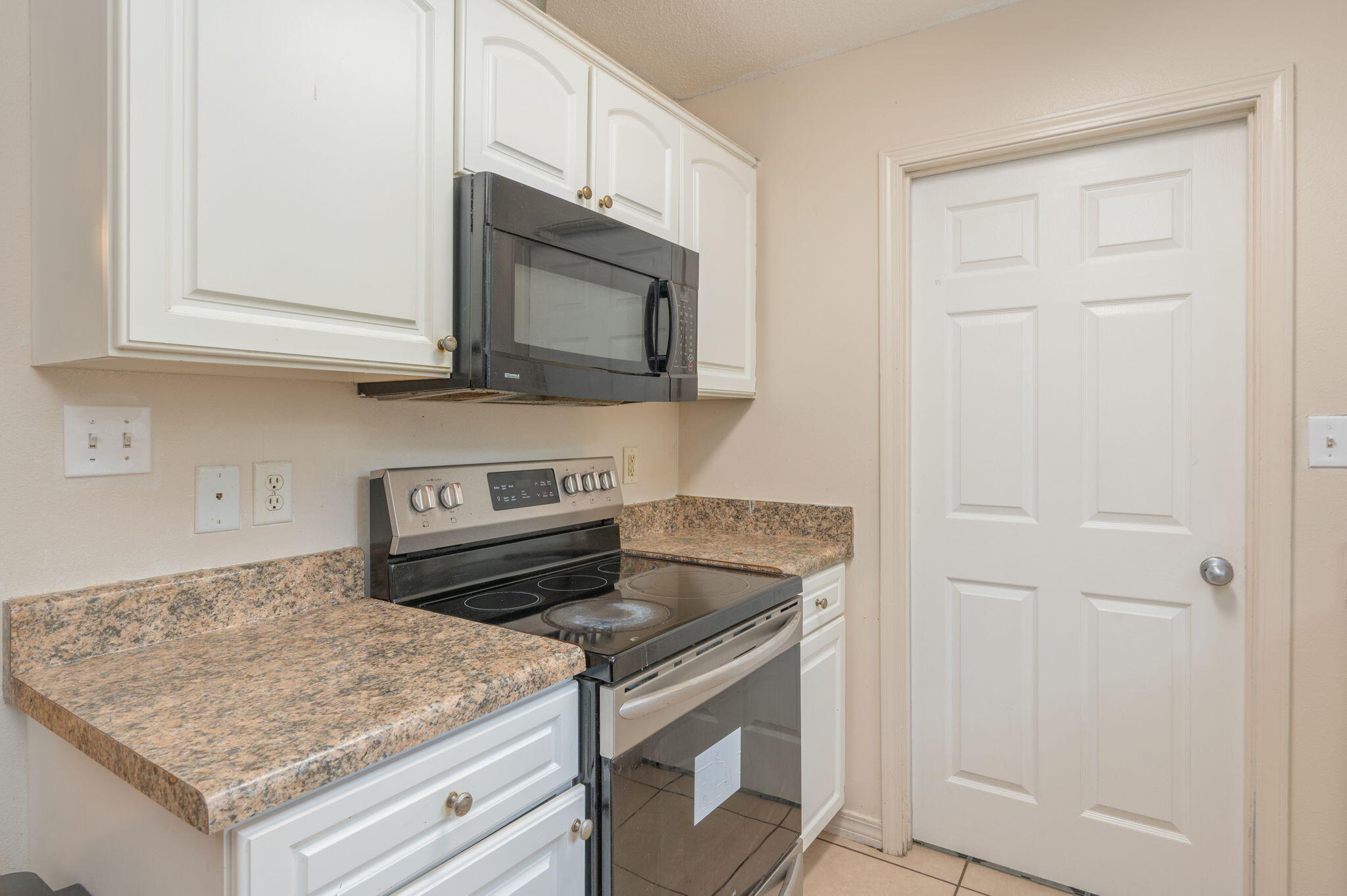 834 McDonald Street Crestview, FL 32536 - Photo 9 of 35 a kitchen with granite countertop cabinets stainless steel appliances and a sink