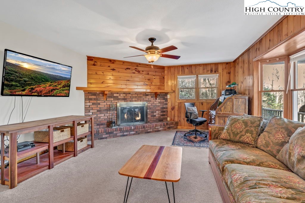 472 Virgil's Lane Boone, NC 28607 - Photo 12 of 44 a living room with furniture a fireplace and a flat screen tv
