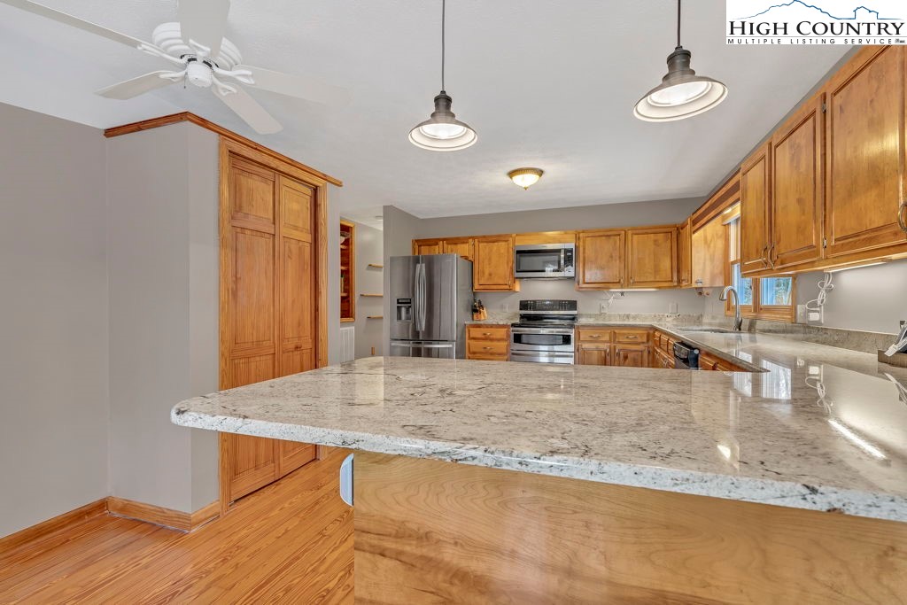 472 Virgil's Lane Boone, NC 28607 - Photo 18 of 44 a view of a kitchen with kitchen island a sink appliances and a counter top space