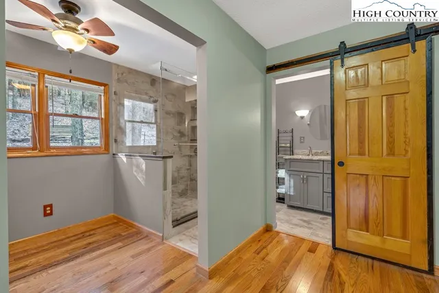a bathroom with a granite countertop sink a toilet and a mirror