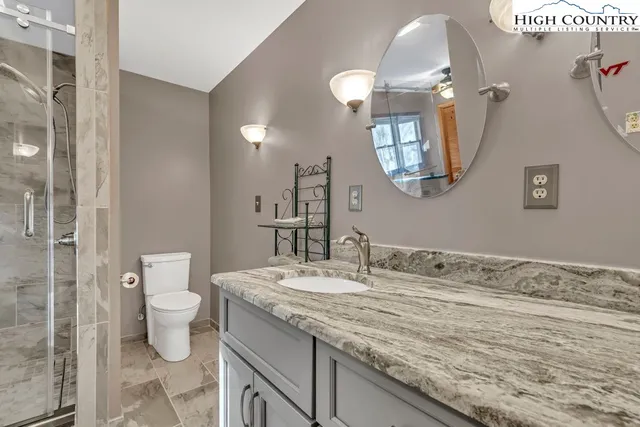 a bathroom with a shower and a sink