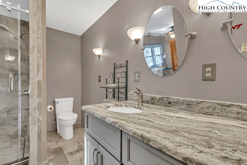 472 Virgil's Lane Boone, NC 28607 - Photo 25 of 44 a bathroom with a granite countertop sink a toilet and a mirror