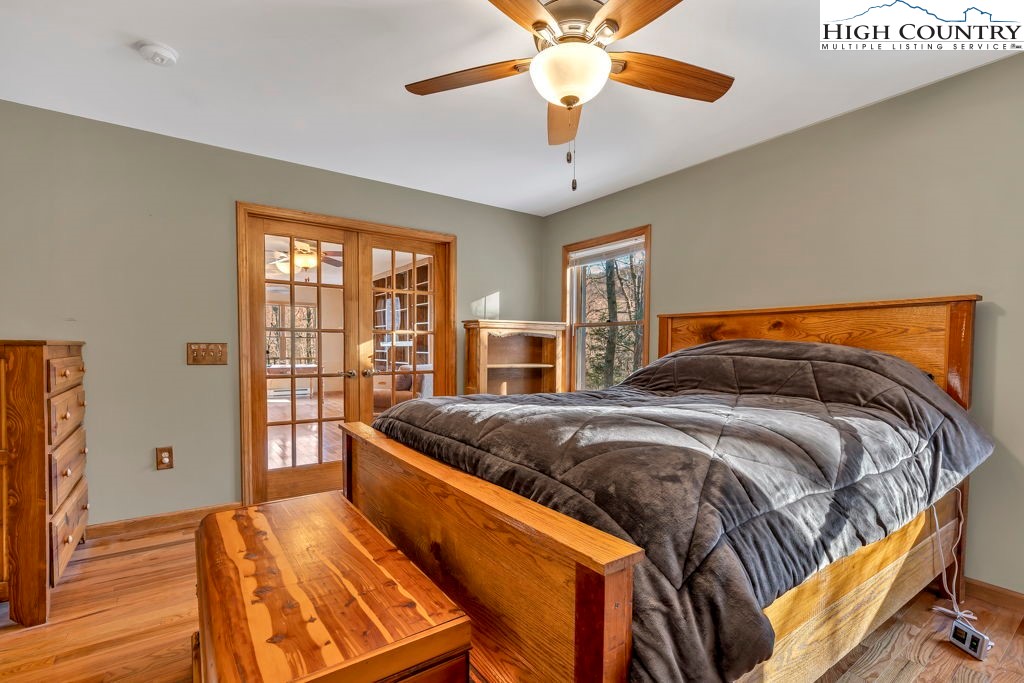 472 Virgil's Lane Boone, NC 28607 - Photo 28 of 44 a bedroom with a bed and wooden floor