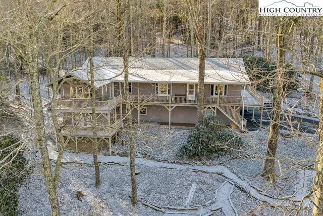 a front view of a house with plants