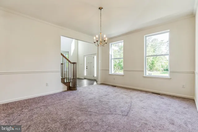 an empty room with windows and entrance