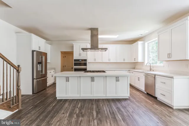 a kitchen with stainless steel appliances a refrigerator sink and cabinets