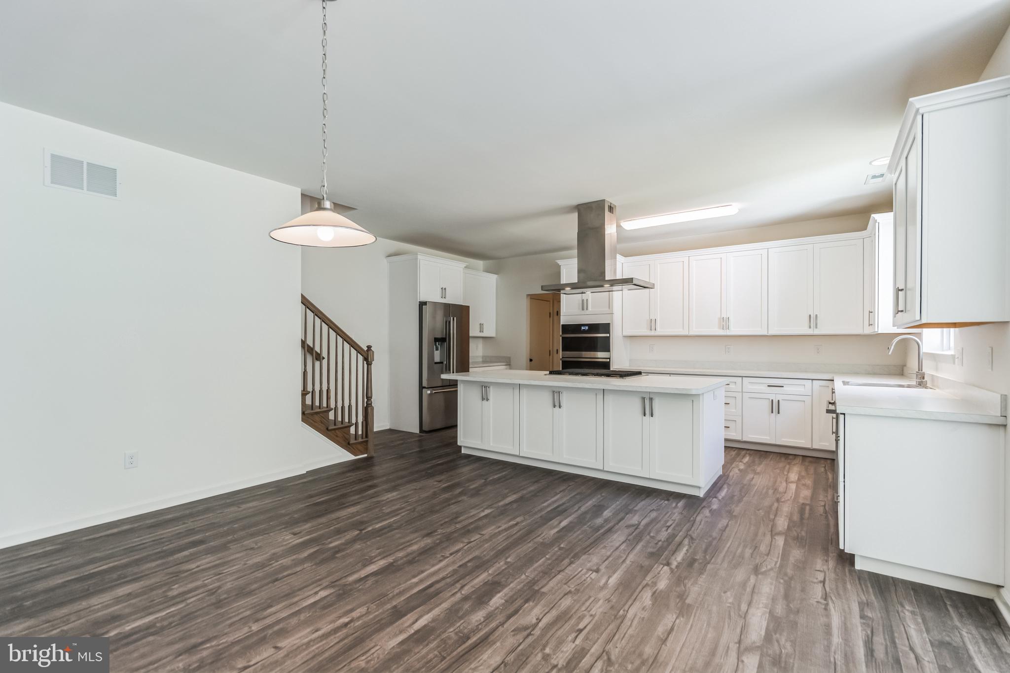848 Saw Mill Road, Unit D Townsend, DE 19734 - Photo 17 of 53 a kitchen with stainless steel appliances a refrigerator and white cabinets