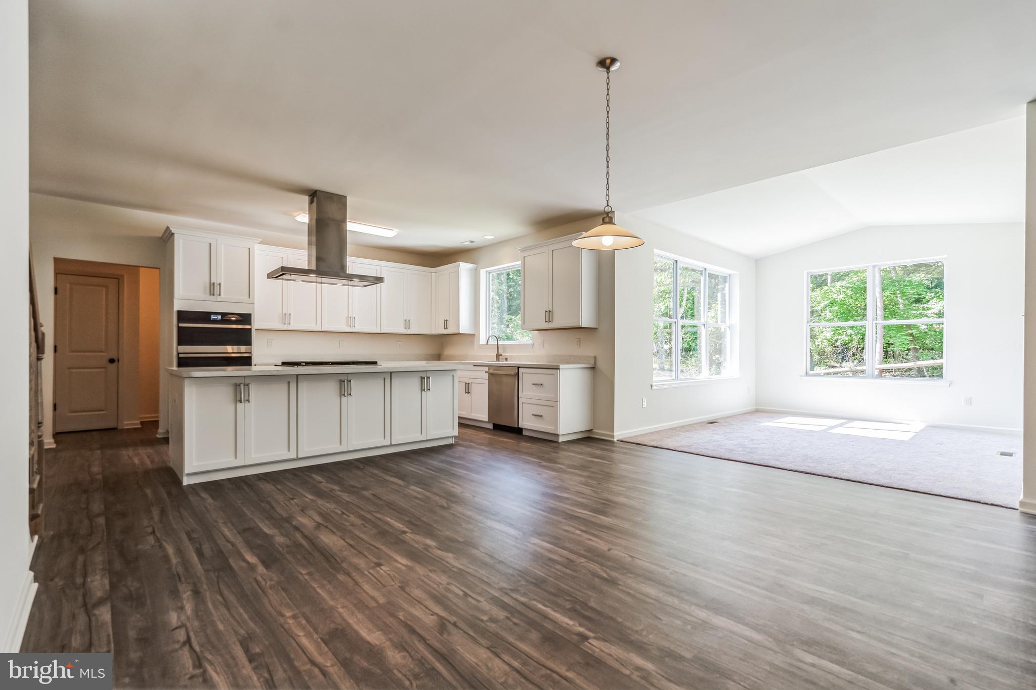 848 Saw Mill Road, Unit D Townsend, DE 19734 - Photo 18 of 53 a view of a kitchen with stainless steel appliances wooden floor and a window