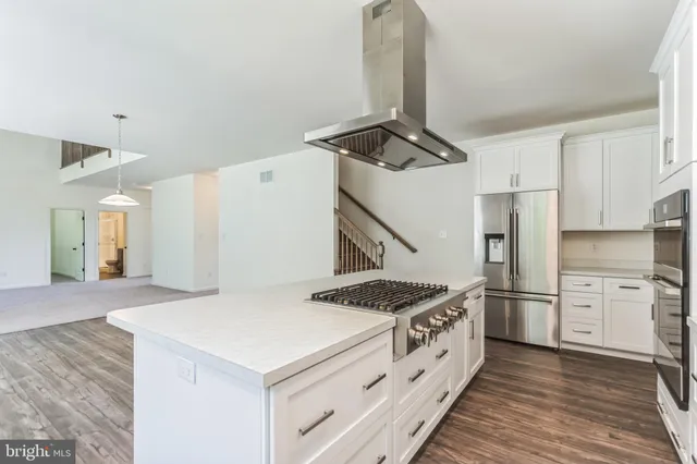 a kitchen with a stove and a refrigerator