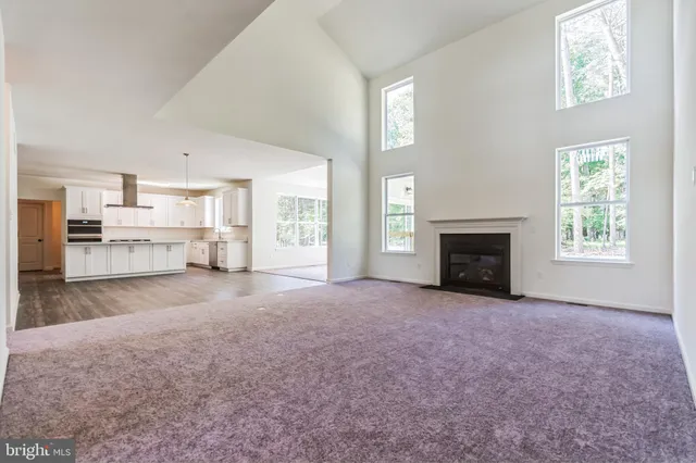 a view of empty room with a fireplace and window