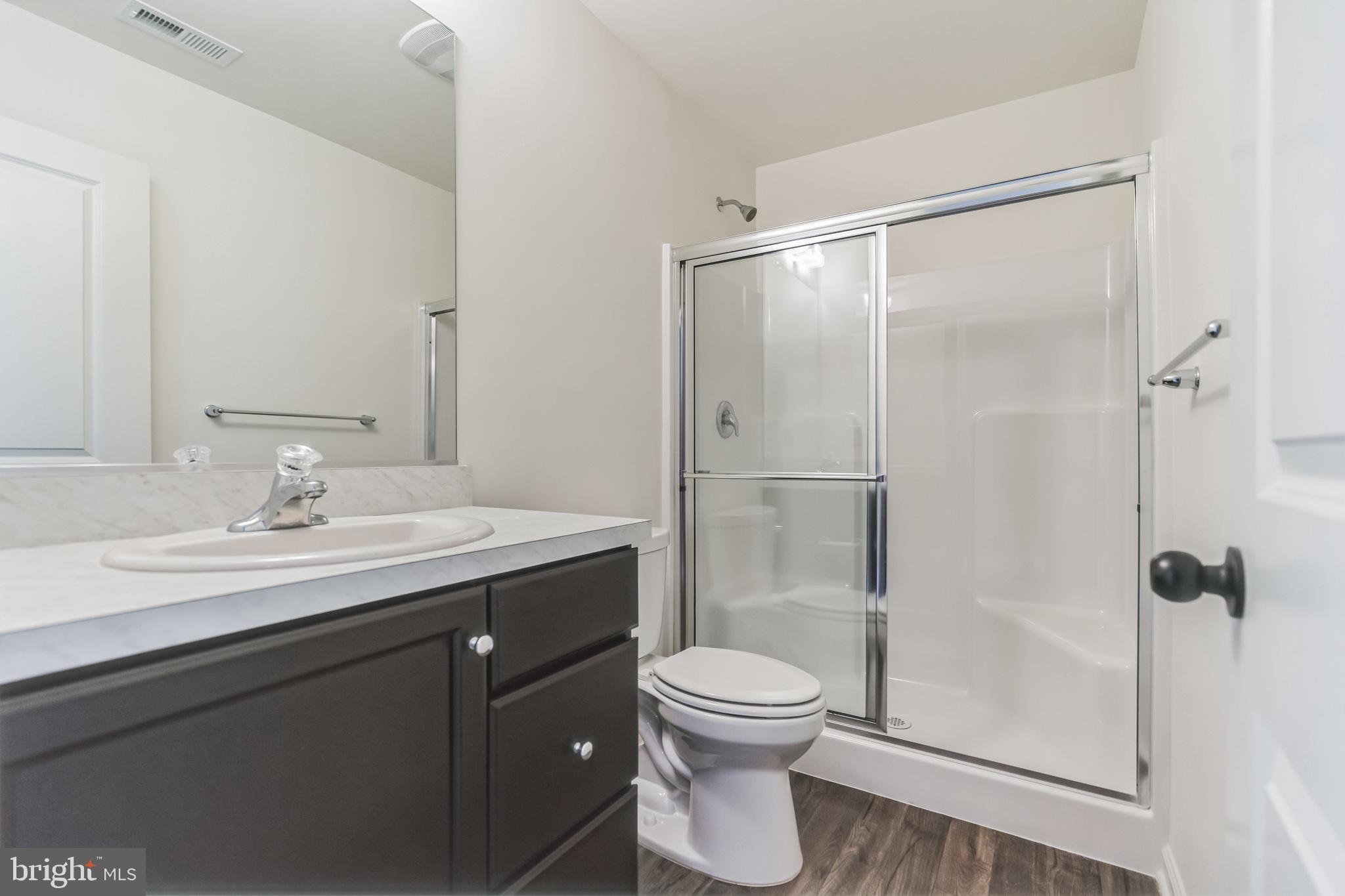 848 Saw Mill Road, Unit D Townsend, DE 19734 - Photo 36 of 53 a bathroom with a granite countertop sink toilet and shower