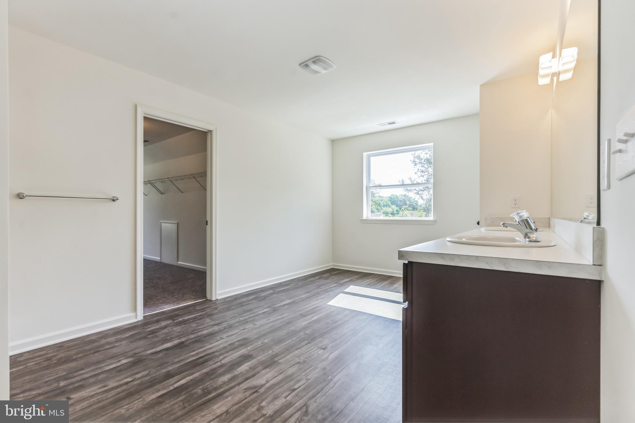 848 Saw Mill Road, Unit D Townsend, DE 19734 - Photo 37 of 53 a bathroom with a sink mirror and window