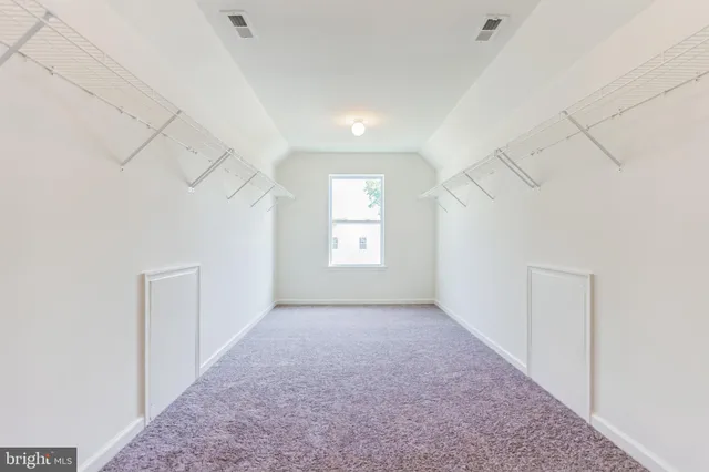 a view of a small space with wooden floor and closet