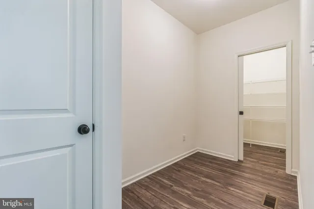 a view of a room that has a sink and wooden floor