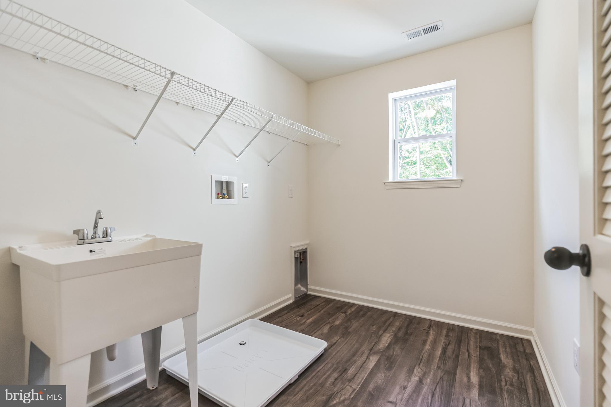 848 Saw Mill Road, Unit D Townsend, DE 19734 - Photo 40 of 53 a view of a room that has a sink and wooden floor