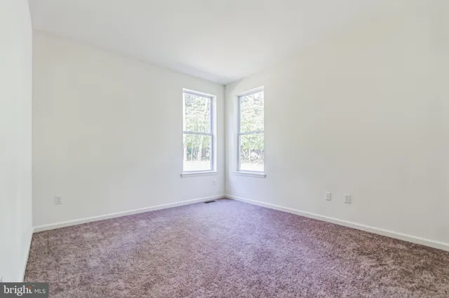 a spacious bathroom with a shower a sink and a mirror