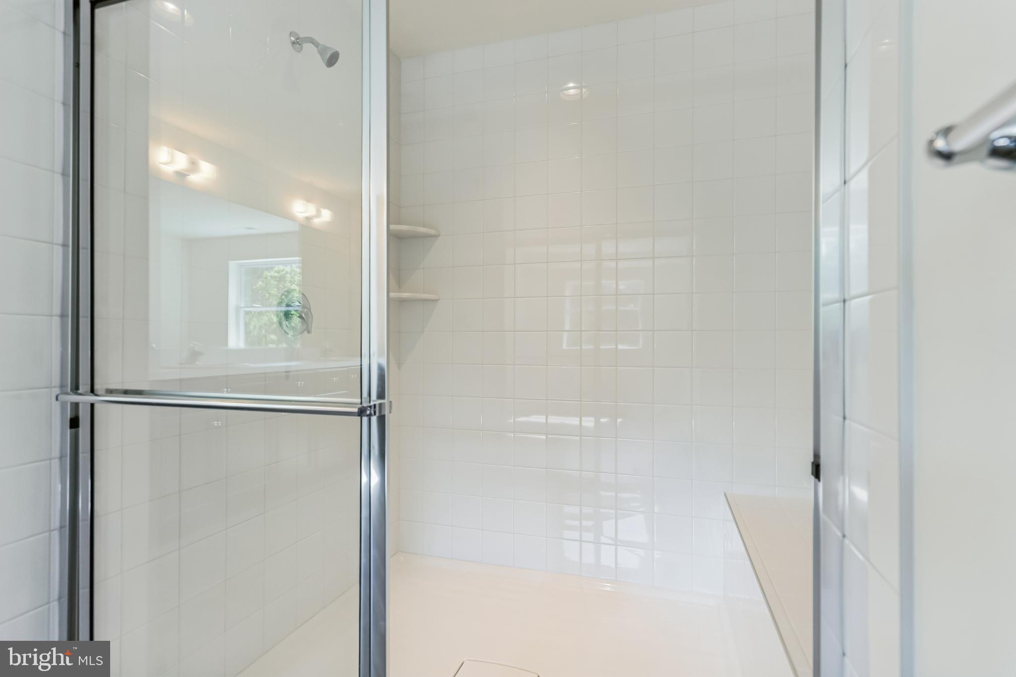 848 Saw Mill Road, Unit D Townsend, DE 19734 - Photo 44 of 53 a bathroom with a glass shower door