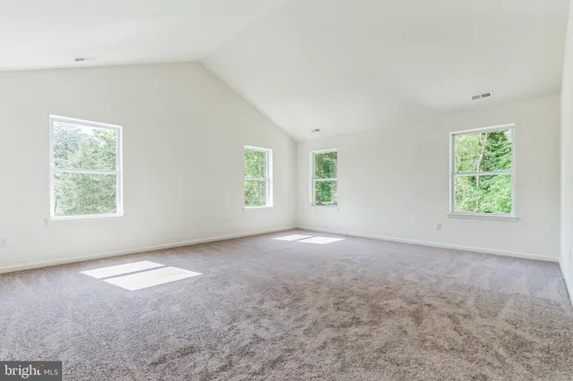 a view of empty room with wooden ceiling