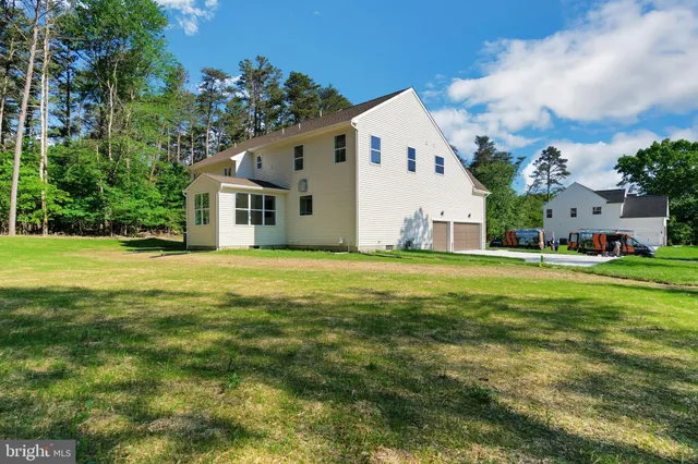 a front view of house with yard and trees