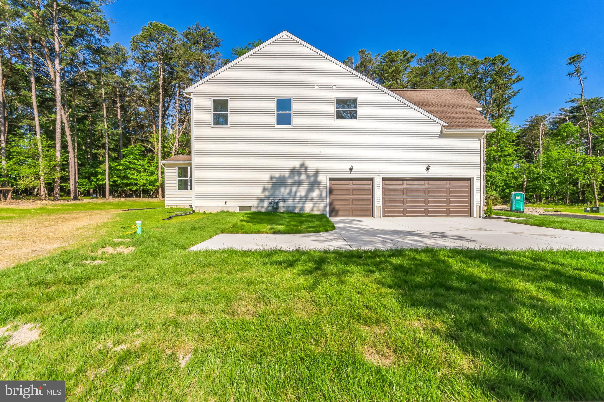 848 Saw Mill Road, Unit D Townsend, DE 19734 - Photo 9 of 53 a view of a white house with a yard and plants