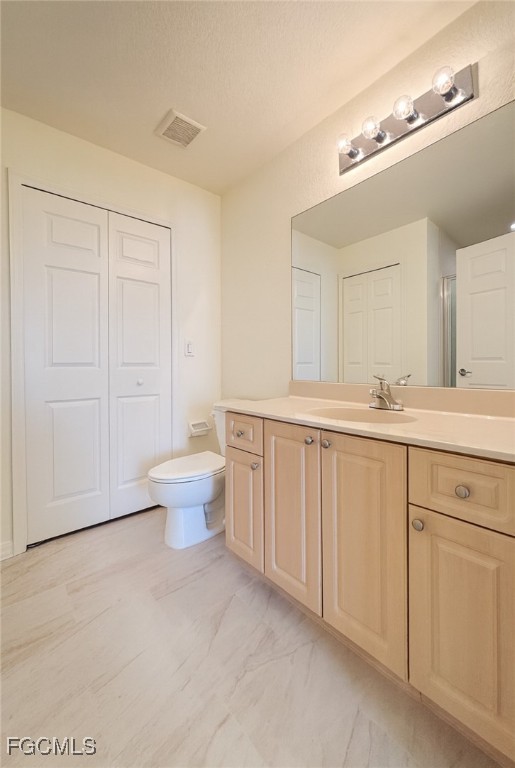 3304 Skyline Boulevard, Unit 202 Cape Coral, FL 33914 - Photo 13 of 20 a bathroom with a sink toilet and a mirror