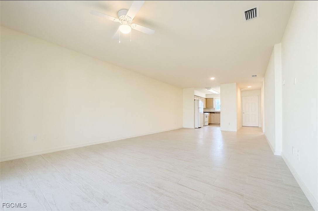 3304 Skyline Boulevard, Unit 202 Cape Coral, FL 33914 - Photo 16 of 20 a view of a kitchen with a sink and a refrigerator