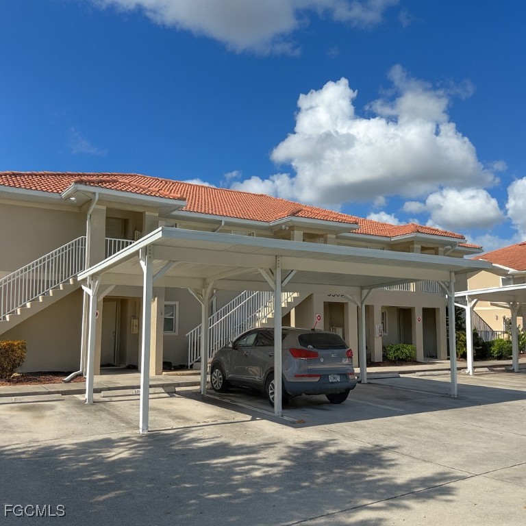 3304 Skyline Boulevard, Unit 202 Cape Coral, FL 33914 - Photo 19 of 20 a view of a car park in front of house