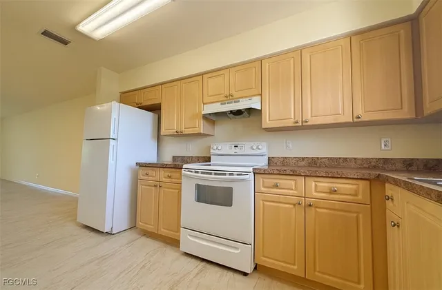 a view of a electric appliances in kitchen and empty room