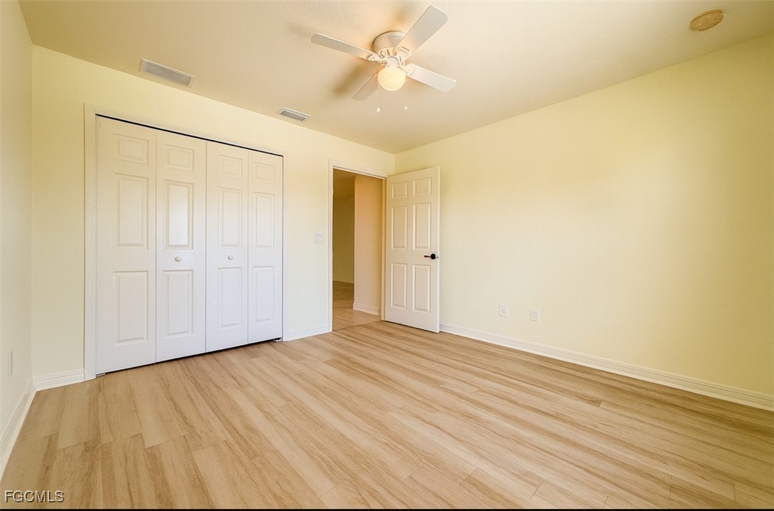 3304 Skyline Boulevard, Unit 202 Cape Coral, FL 33914 - Photo 8 of 20 wooden floor in an empty room