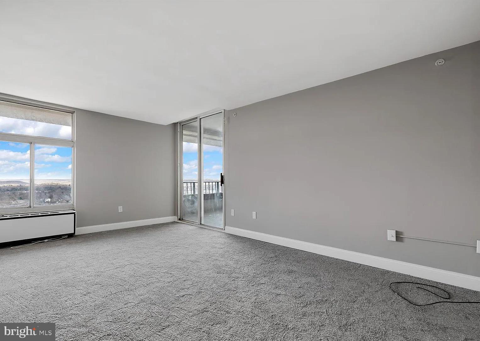 28 Allegheny Avenue, Unit 2502 Towson, MD 21204 - Photo 13 of 22 a view of an empty room with wooden floor and windows