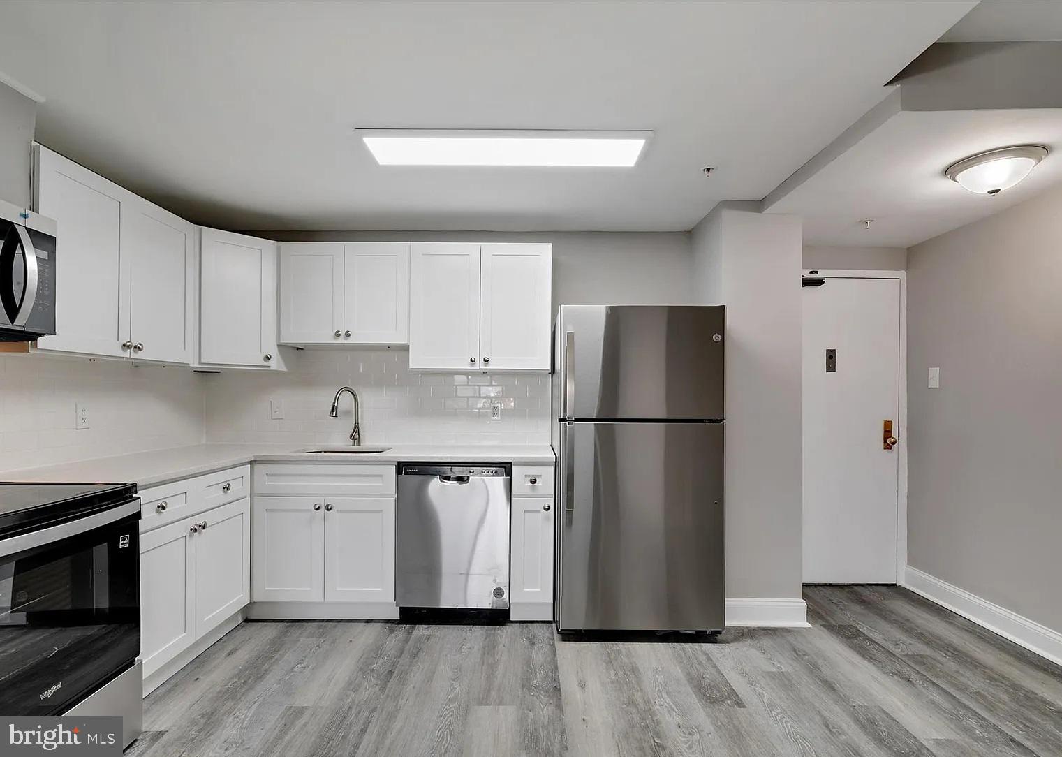 28 Allegheny Avenue, Unit 2502 Towson, MD 21204 - Photo 2 of 22 a kitchen with a refrigerator a sink and cabinets