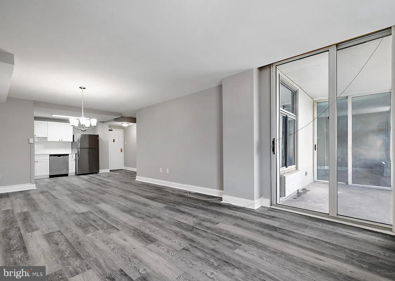 28 Allegheny Avenue, Unit 2502 Towson, MD 21204 - Photo 4 of 22 a view of a big room with wooden floor and a kitchen