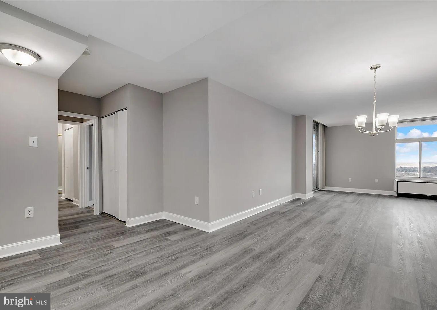 28 Allegheny Avenue, Unit 2502 Towson, MD 21204 - Photo 6 of 22 an empty room with wooden floor and windows
