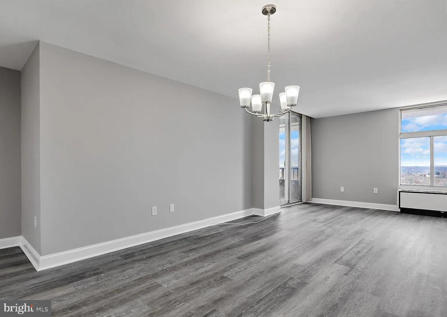 28 Allegheny Avenue, Unit 2502 Towson, MD 21204 - Photo 7 of 22 a view of an empty room with wooden floor and a window